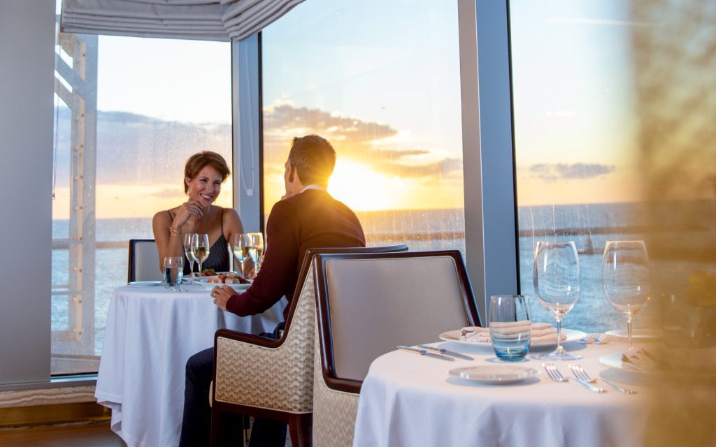 Couple eating dinner in sunset on a cruise ship