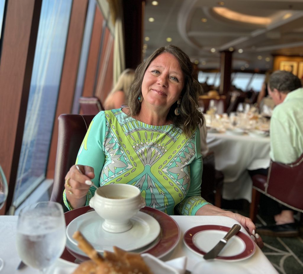 Mary Ann dining onboard cruise ship during Riviera cruise with Oceania and Viking Travel