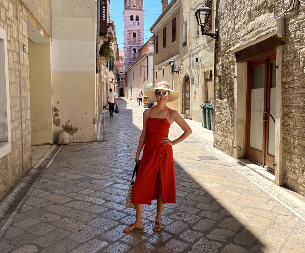 Rebecca stood in historic cobblestone street on the Boka Bay Catamaran Cruise with Viking Travel and Oceania Cruises - Viking Travel