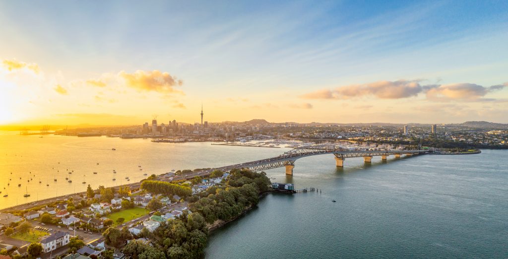 Auckland, with the Sky Tower and CBD visible across Waitemata Harbor and the Auckland Harbour Bridge - Viking Travel