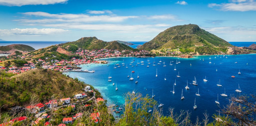 Colorful image of Guadeloupe Terre de Haut bay and town with buildings along the coastline - Viking Travel