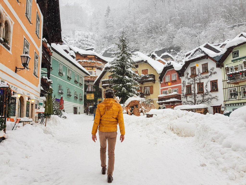 A back view of a young male walking on the street of a mountain resort town in Austria - Viking Travel