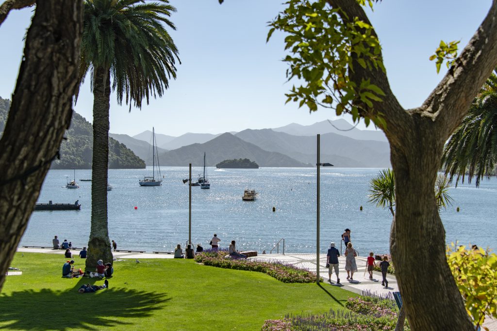 People relaxing at the beach in the city of Picton, New Zealand - Viking Travel