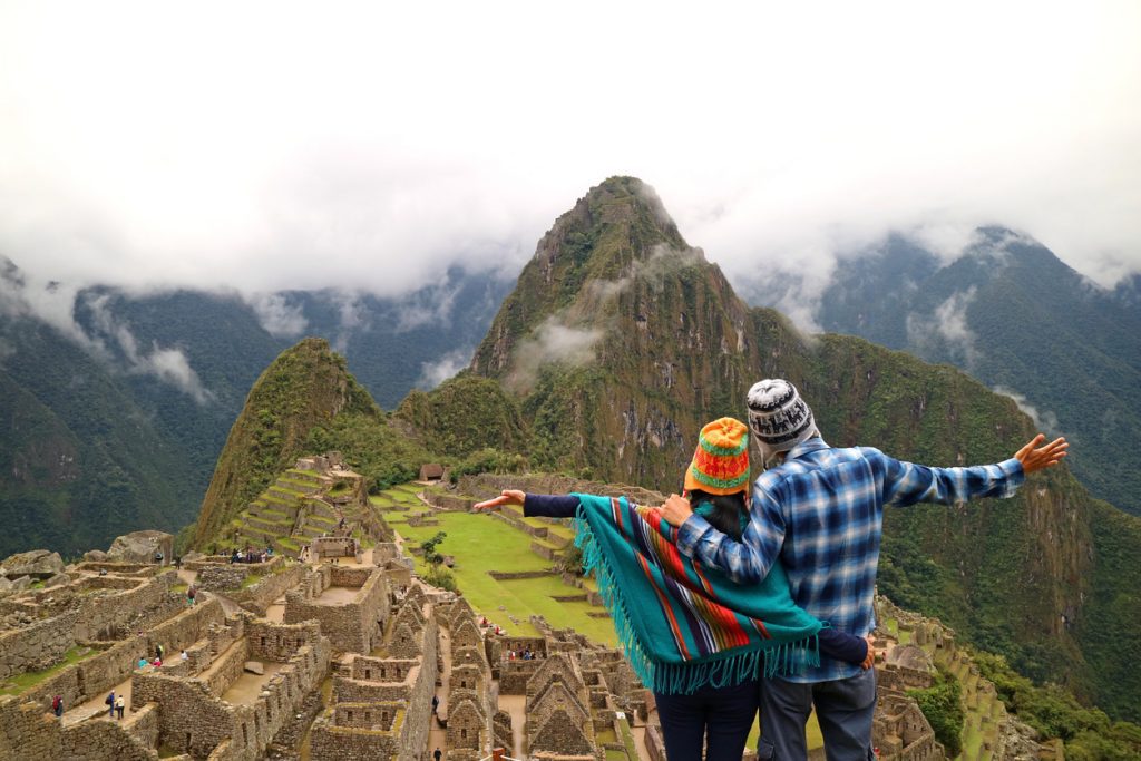 Couple admiring the spectacular view of Machu Picchu, Cusco Region, Urubamba Province, Peru - Viking Travel