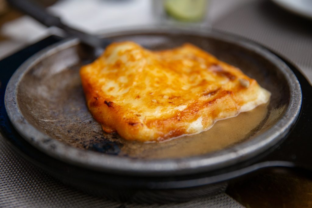 Searing Saganaki Cheese on a skillet - Viking Travel